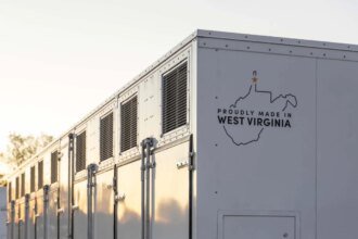 A grid-scale battery stands against a clear sky.